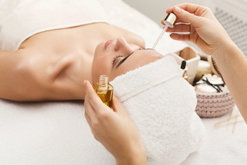Woman getting professional facial massage at spa salon