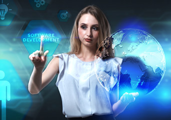 The concept of business, technology, the Internet and the network. A young entrepreneur working on a virtual screen of the future and sees the inscription: Software development