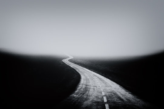 Fototapeta country road with moody fog and cold rainy weather