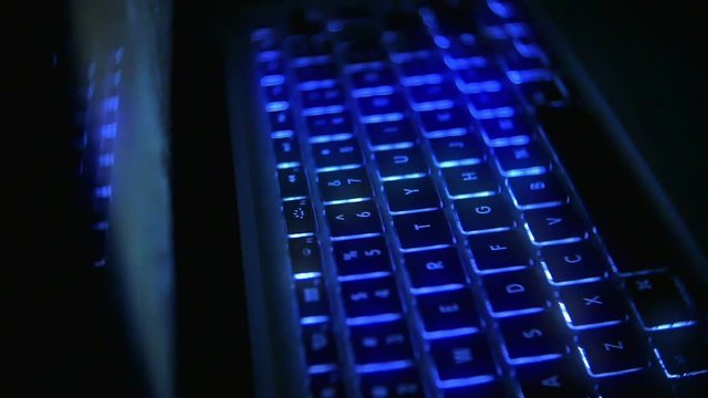 Laptop Keyboard Glowing Blue Light at Night in Slow Motion