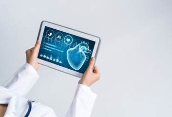 Close of female doctor hands working with tablet pc computer