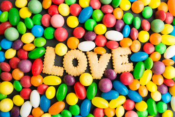 Fototapeta na wymiar Concept of candies love, colorful candies with cookies