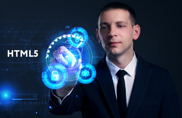 Business, Technology, Internet and network concept. Young businessman working on a virtual screen of the future and sees the inscription: HTML5