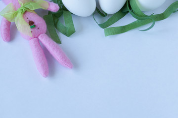 White eggs and Easter Bunny on white background. Space for text