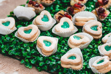 Delicious cookies hearts sweet colorful dessert green and white for birthday party on a candy bar
