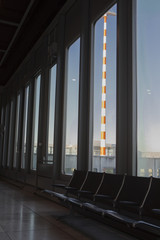 Overseas vacation travel, airport waiting room floor window, towering lighthouse