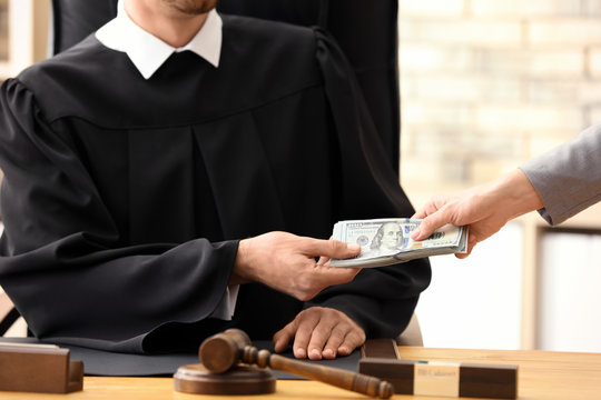 Male judge taking bribe from woman, closeup