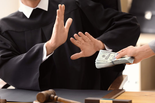 Male judge refusing to take bribe from woman, closeup