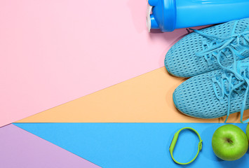 Gym stuff and blank space for exercise plan on color background. Flat lay composition