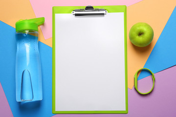 Clipboard with blank paper for exercise plan and gym stuff on color background. Flat lay composition