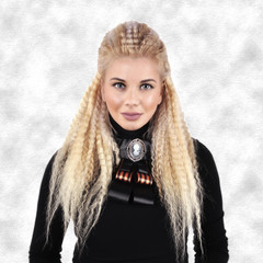 young girl with long blond hair in a black sweater with a brooch