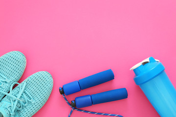 Gym stuff and blank space for exercise plan on color background. Flat lay composition