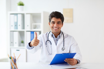 happy doctor at clinic showing thumbs up