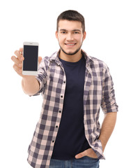 Young man with cell phone on white background