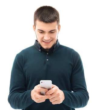 Young man using cell phone against white background
