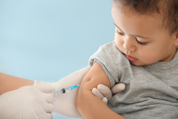 Doctor vaccinating little baby in hospital