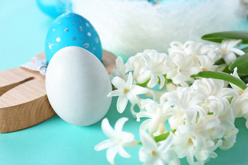 Flowers and dyed Easter eggs on table