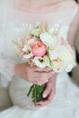 wedding bouquet in the hands of the bride