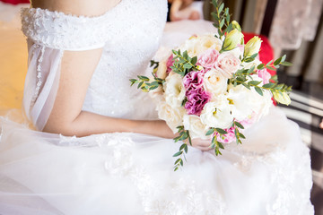 Bride holding beautiful wedding bouquet.