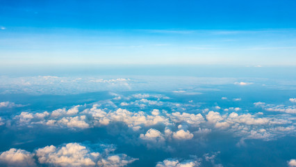 Fototapeta na wymiar Beautiful Sunrise above clouds from airplane window