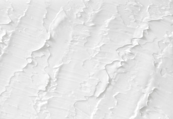 Texture of white paint on the wall. A background with continuous lines painted with brushes, handmade.