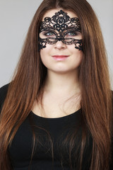 Mysterious woman wearing lace mask