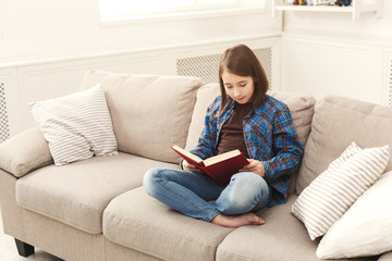 Cozy home. Young thoughtful girl with book