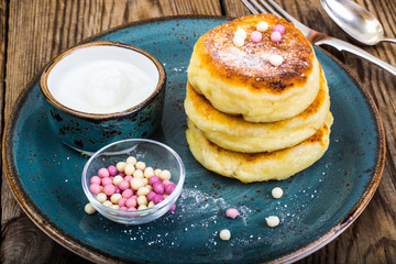 Hot delicious curd pancakes with fruit salad and yogurt