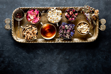 Healing Herbs and Herbal tea in a metal tray and copy space for text