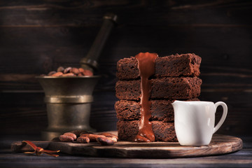 Pieces brownie chocolate cake and warm chocolate sauce.