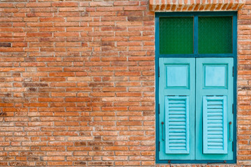 blue wooden window in brick wall