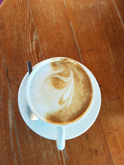 cappuccino coffee isolated in white and wood  - drink background