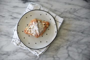 Breakfast pastry on spotted plate, overhead view