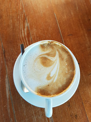 cappuccino coffee isolated in white and wood  - drink background