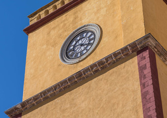 An isolated, close-up of the clock tower, a portion of The Church of the Basilica, in Guanajuato, Mexico - 191374902