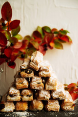 Strudel Apple and sugar powder. Biscuit from the puffed Test on the Gray Background. Dessert with Fruits.Copy space for Text. selective focus.