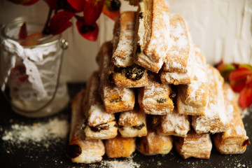 Strudel Apple and sugar powder. Biscuit from the puffed Test on the Gray Background. Dessert with Fruits.Copy space for Text. selective focus.