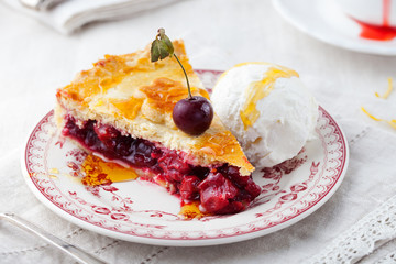 Slice of cherry pie with ice cream