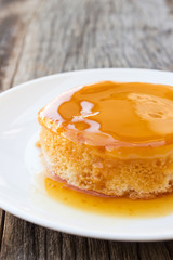 Homemade caramel custard cake on white plate. French dessert.