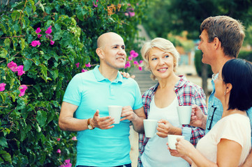 pensioners talking in the park and drinking coffee