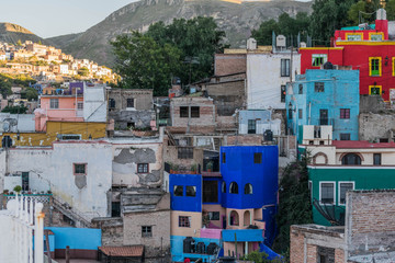 Isolated shot of a vivid blue and many other colorful houses, dotting the hillside, in Guanajuato, Mexico - 191376990