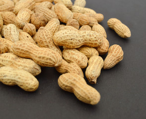 Dried peanuts in closeup on black background