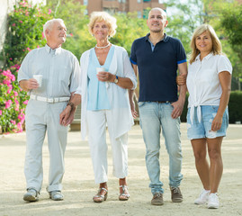 happy elderly friends walking outdoor