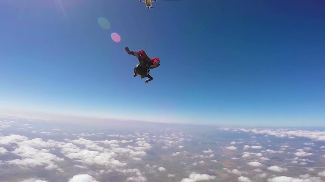 Parachutist jumping in tandem out of an sport airplane