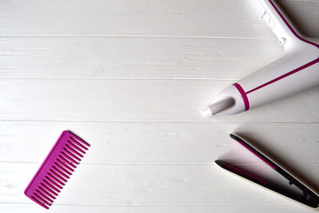 Hair care instruments. Beauty salon. Hair care tools on the white wooden background.