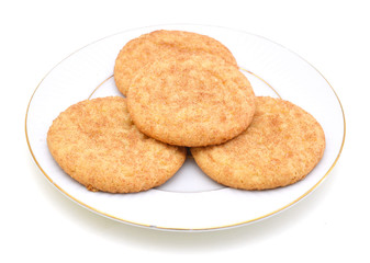 Stack of snickerdoodles in white plate on white