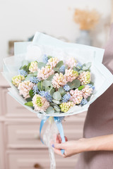 beautiful luxury bouquet of pink hyacinths flowers in woman hand. the work of the florist at a flower shop.