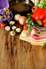 Ingredients for cooking fried eggs with vegetables on wooden background