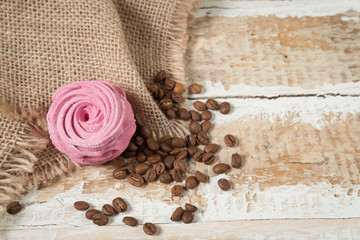 homemade marshmallow cake with currant, mint and Apple addition preparations and coffee beans on a rough wooden surface