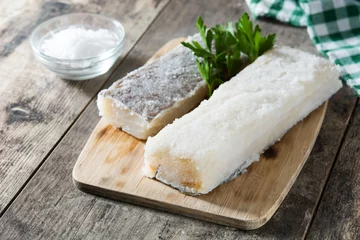 Poster Salted dried cod on wooden table. Typical Easter food © chandlervid85